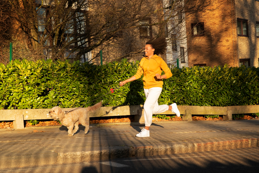 Woman jogging with dog in park